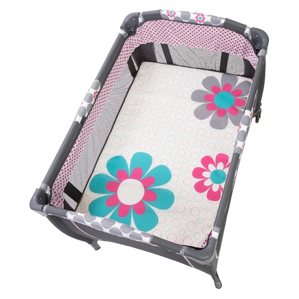 Lil' Snooze™ Deluxe II Nursery Center® Play yard, Daisy Dots Cozy napper with canopy and 2 plush toys