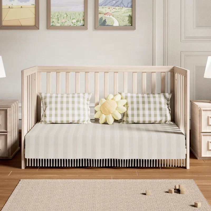 11-in-1 Convertible Baby Crib With Removable Wheels, Washed Natural New Zealand Pinewood Finish, and 4 Mattress Heights.