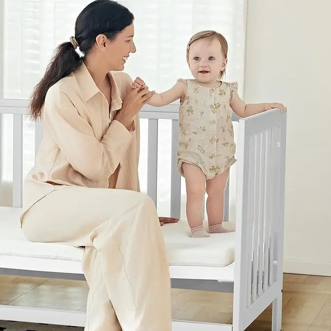 6-in-1 Adjustable Portable Mini White Crib including Mattress and made of New Zealand PInewood.