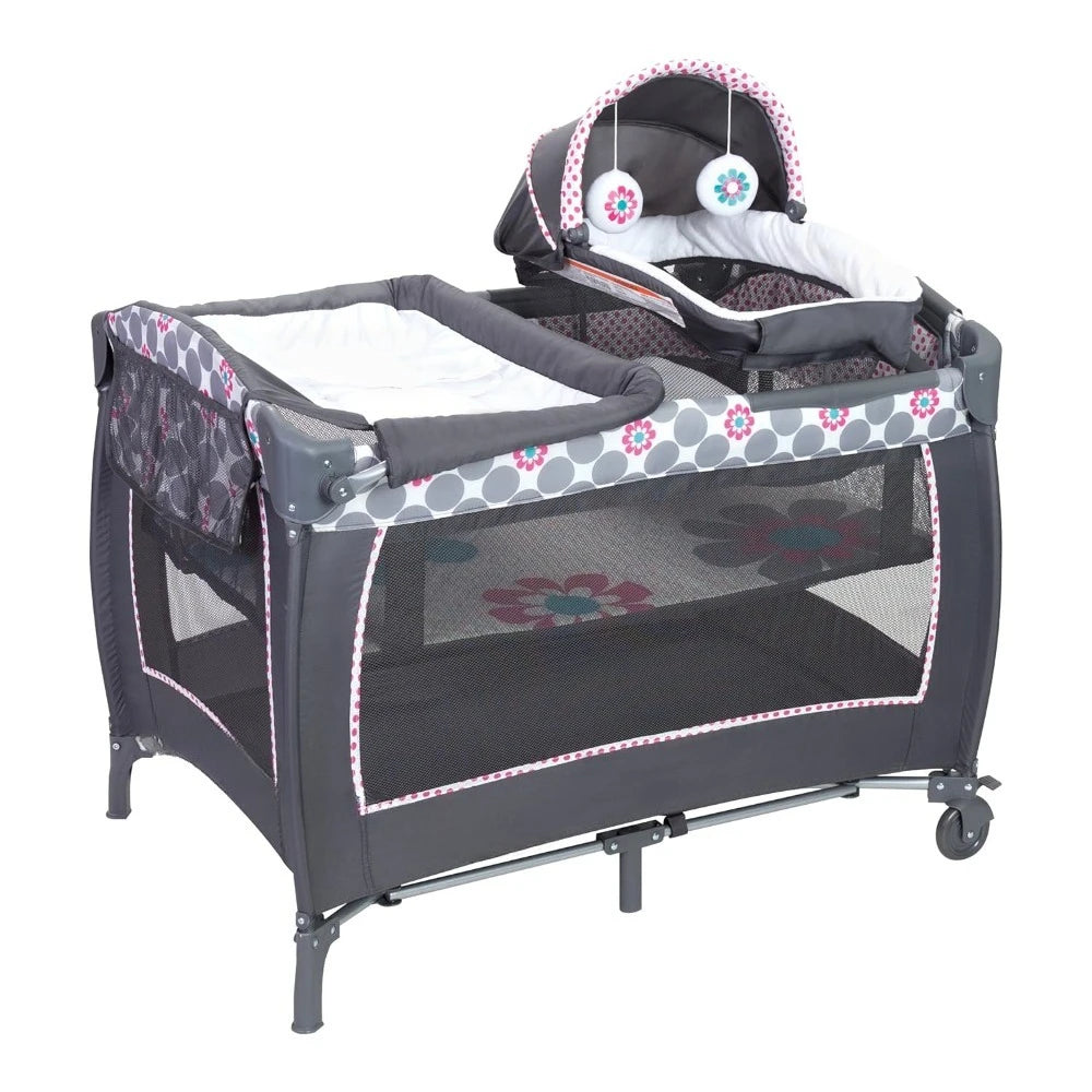 Lil' Snooze™ Deluxe II Nursery Center® Play yard, Daisy Dots Cozy napper with canopy and 2 plush toys